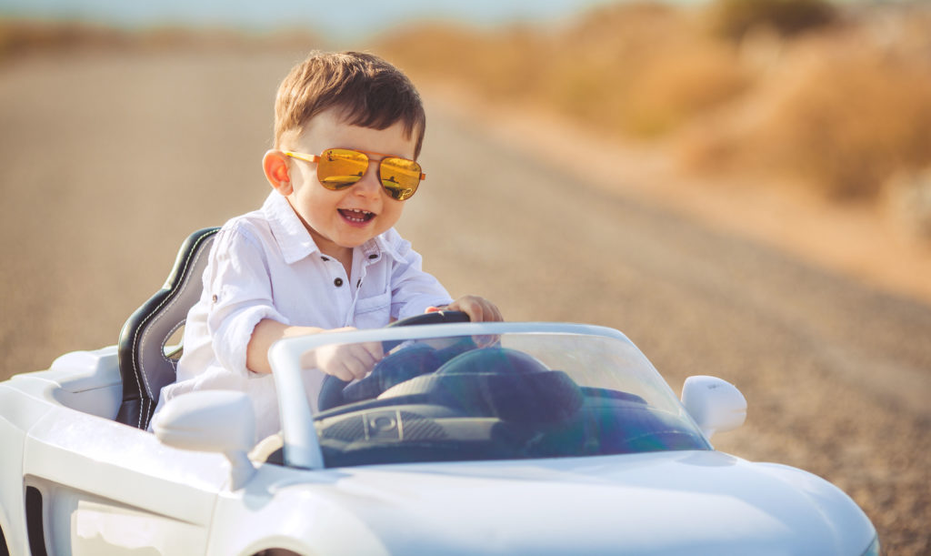 kids sit in toy cars