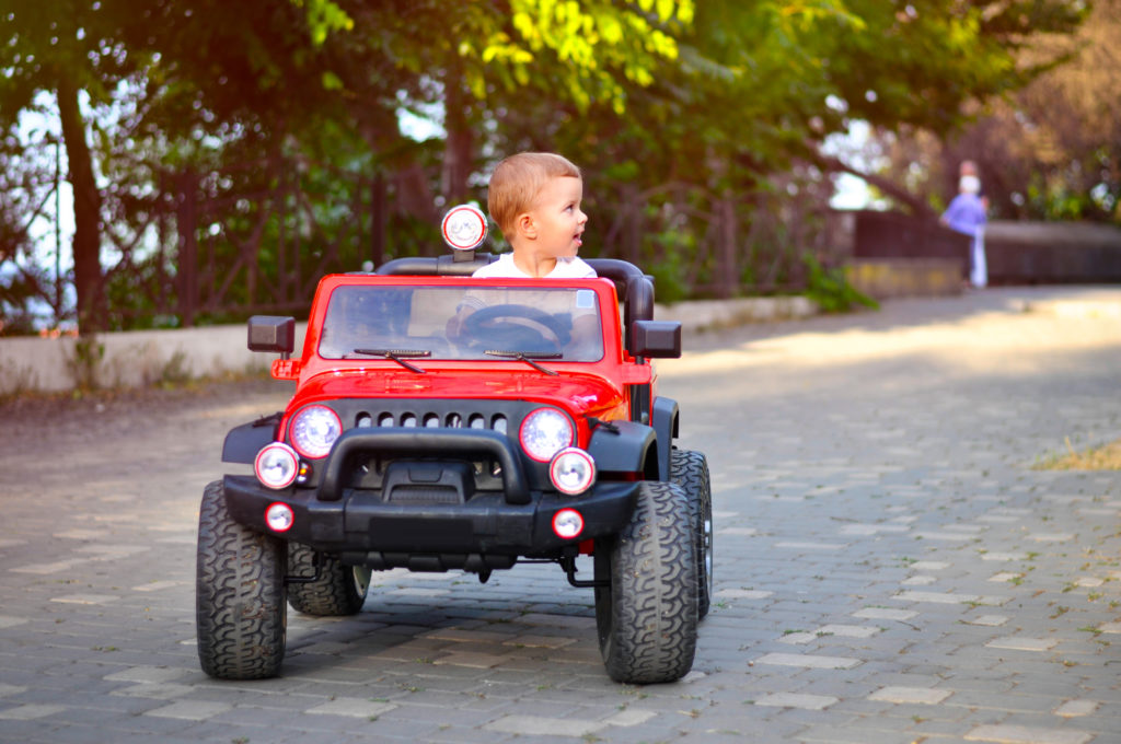 kids sit in toy cars